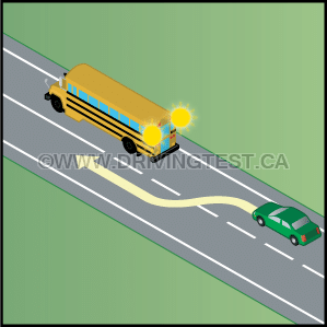 Driving Test Canada - Car Test 3 - If a school bus has flashing yellow lights, what should you do?